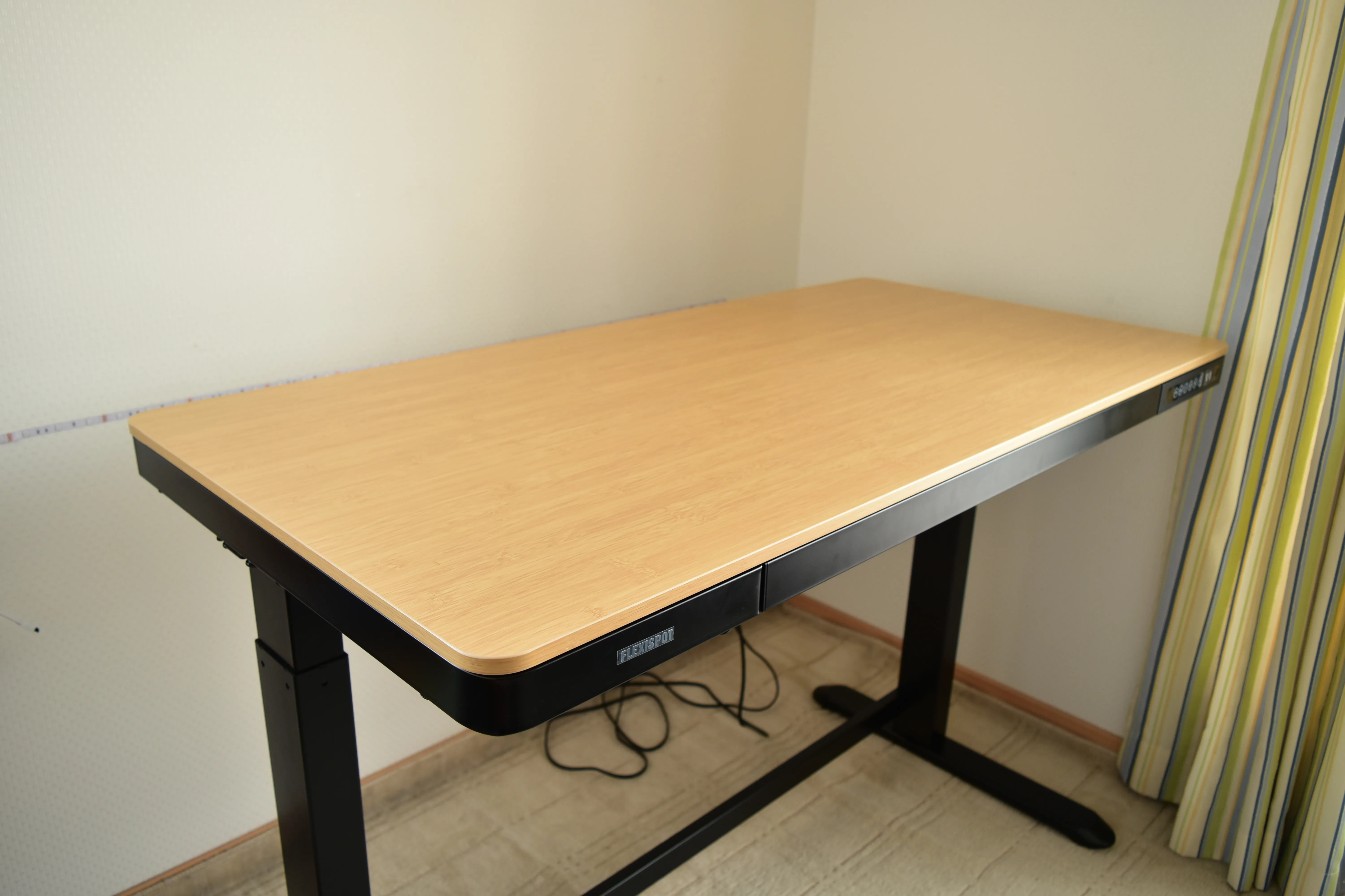 部屋の角に設置したFLEXISPOT EB8Z(木目の天板のスタンディングデスク)